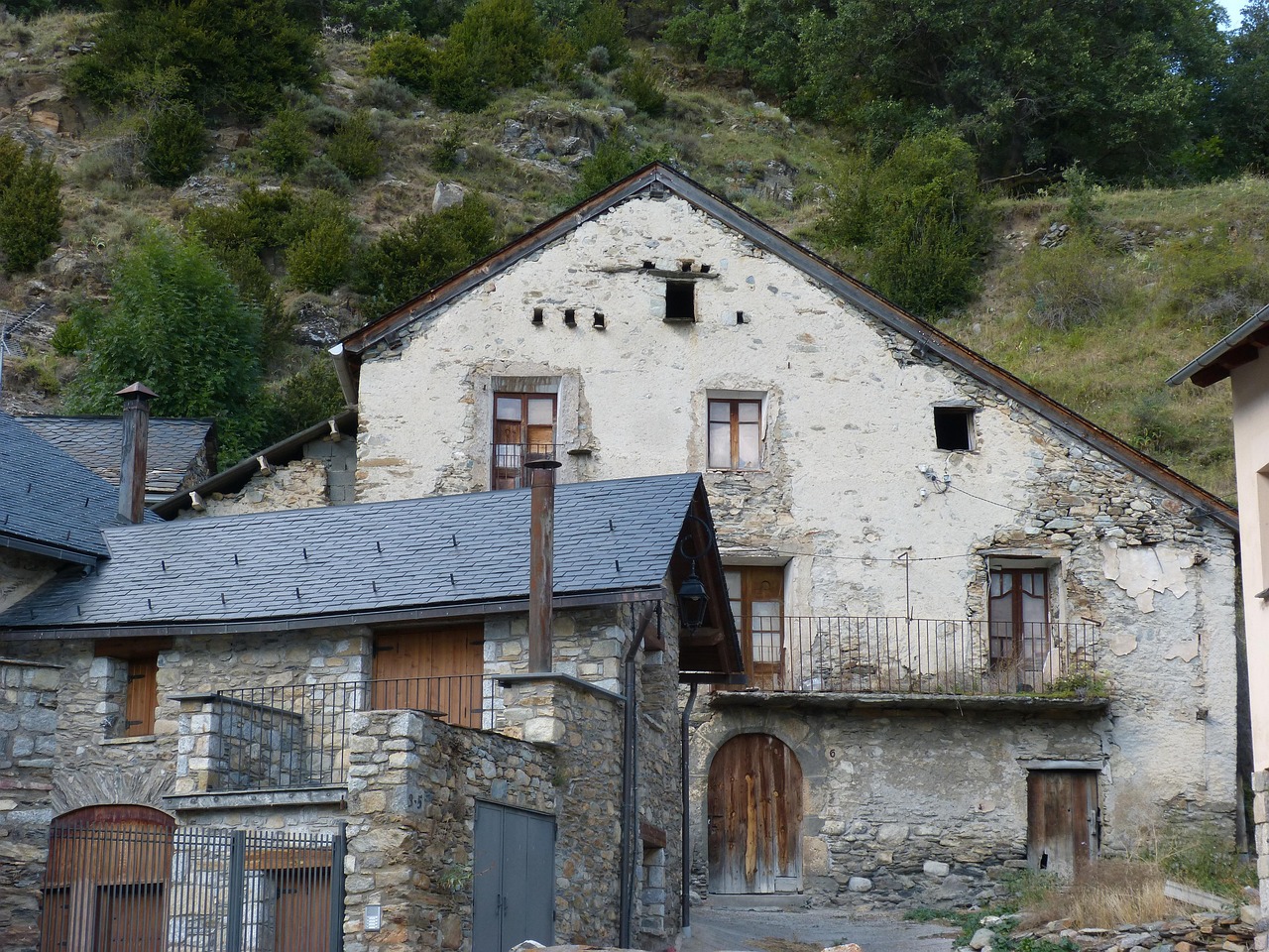 Old stone farmhouse at the foot of the mountain