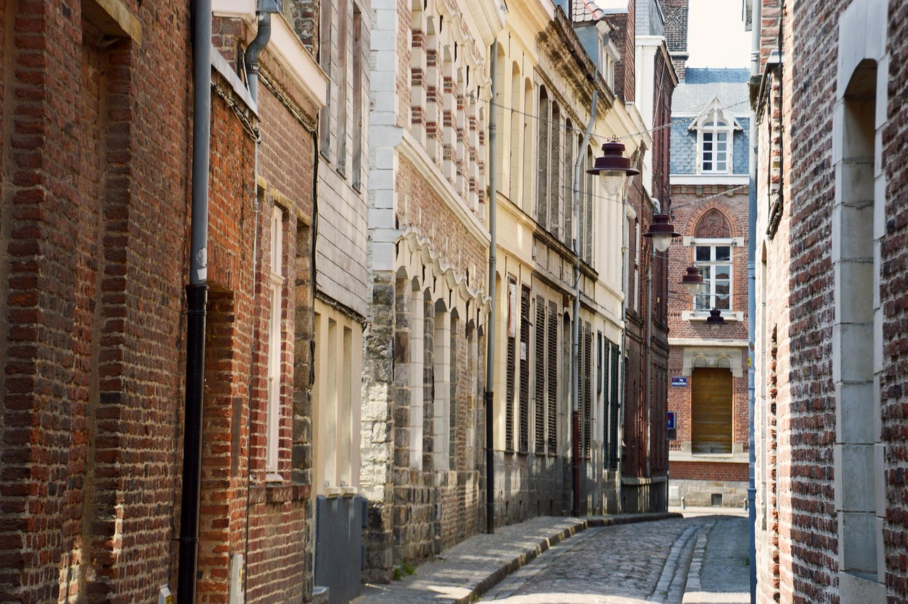 quiet cobbled side street lined with brick and stone facades